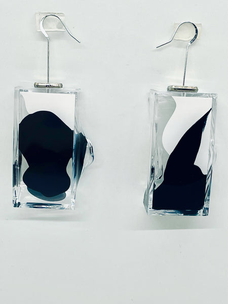 Hand molded by the artist, these lightweight, transparent drop earrings from the Nodes Collection of art jewelry are hand painted with black and white acrylic paint; they swivel as you do to reveal multiple views! Wear them as your own mini gallery and start a conversation! Drop approximately, 2.5 inches, transparent plexiglas original artwork